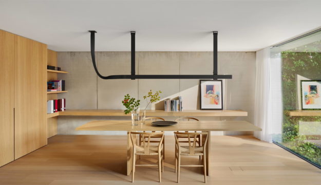 A modern dining room lit by unique linear lighting